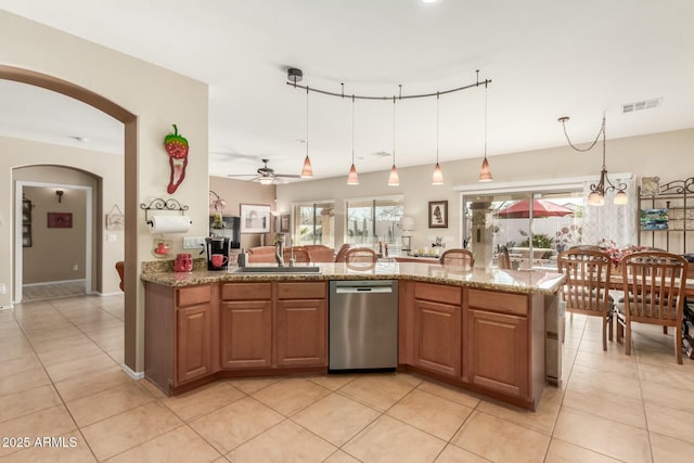 kitchen featuring sink, stainless steel dishwasher, ceiling fan, light stone countertops, and light tile patterned floors