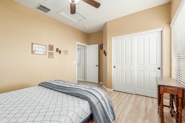 bedroom featuring ceiling fan, a closet, and light wood-type flooring