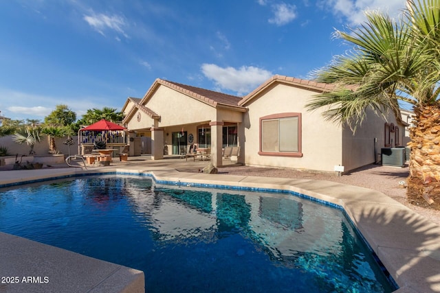 view of swimming pool featuring a gazebo, cooling unit, and a patio area