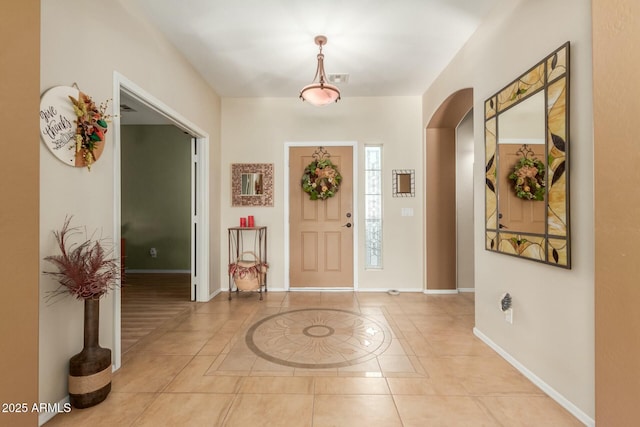 foyer entrance with light tile patterned floors