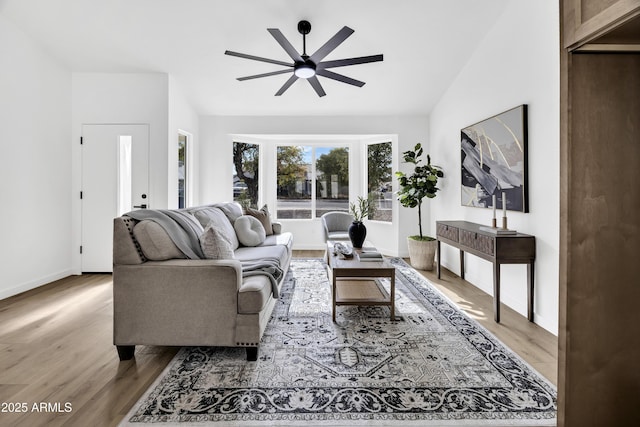 living room featuring lofted ceiling, hardwood / wood-style floors, and ceiling fan