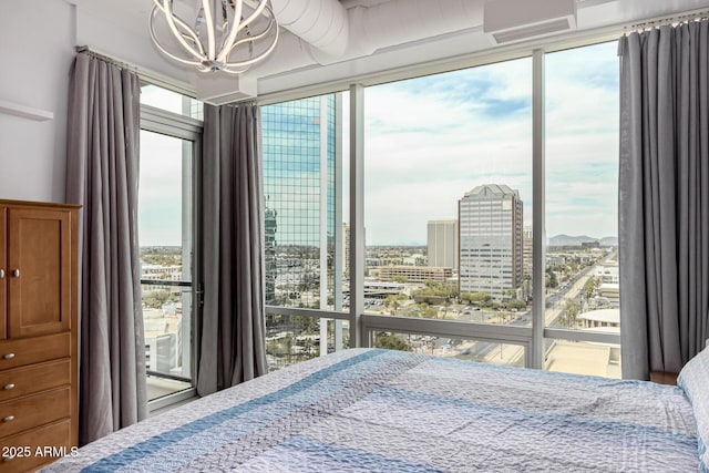 1 E Lexington Ave Unit 1108, Phoenix, AZ 85012 - bedroom featuring multiple windows, a chandelier, a city view, and access to exterior