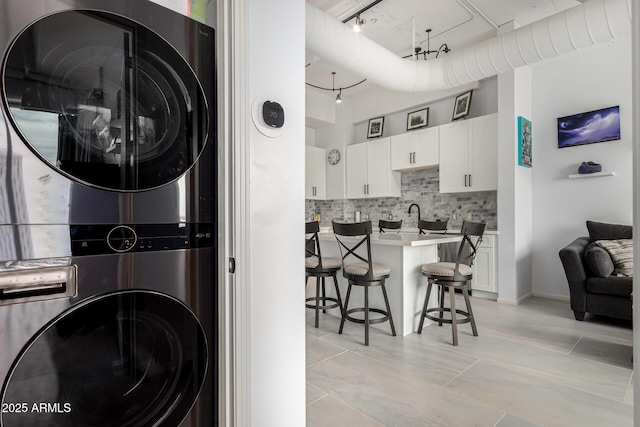 1 E Lexington Ave Unit 1108, Phoenix, AZ 85012 - washroom featuring stacked washer and clothes dryer and track lighting