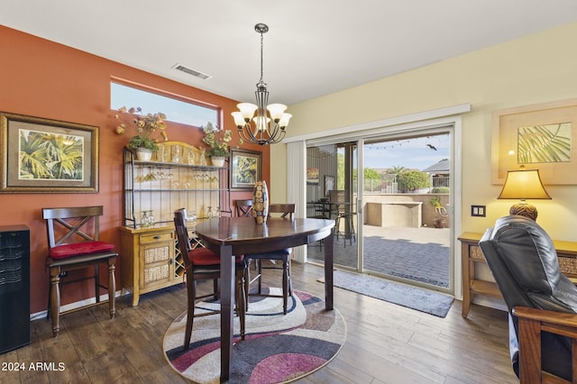 dining area featuring an inviting chandelier and dark hardwood / wood-style flooring