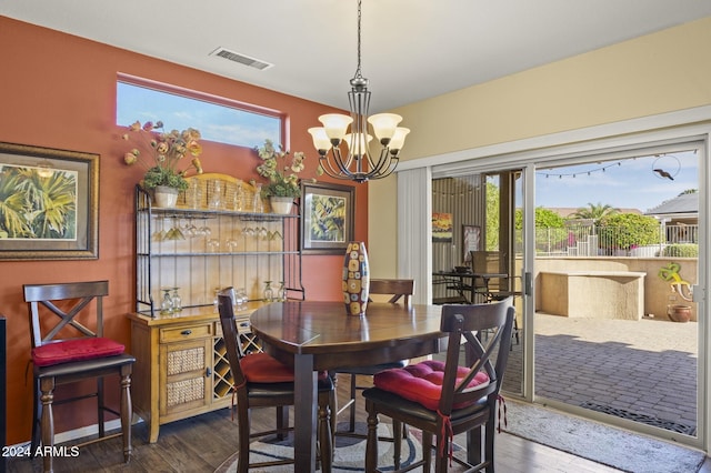 dining room featuring an inviting chandelier, dark hardwood / wood-style flooring, and a wealth of natural light