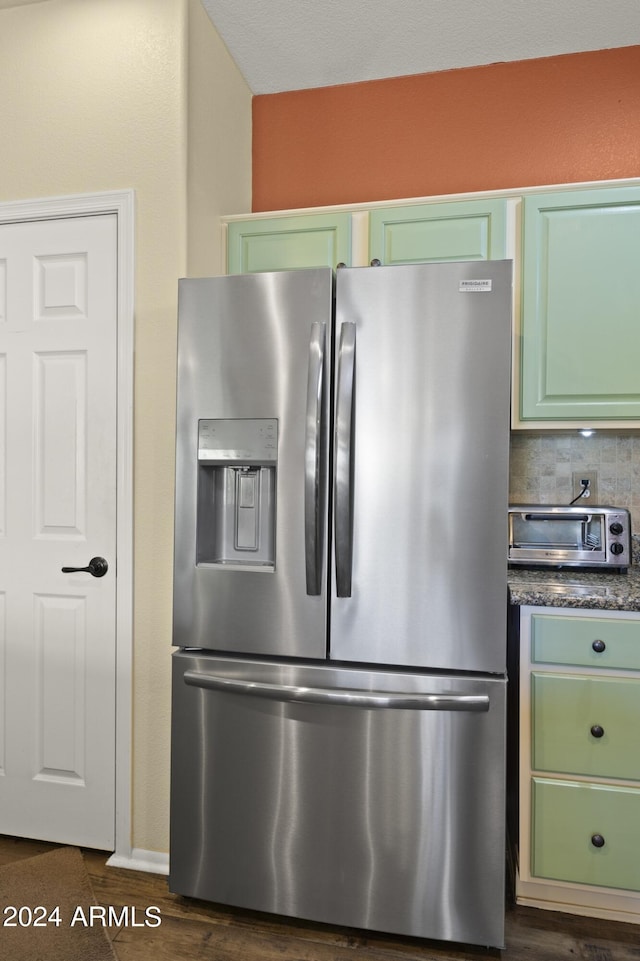 kitchen with stainless steel fridge with ice dispenser, decorative backsplash, and dark hardwood / wood-style flooring