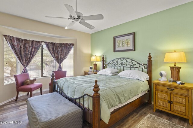 bedroom with ceiling fan and dark hardwood / wood-style floors