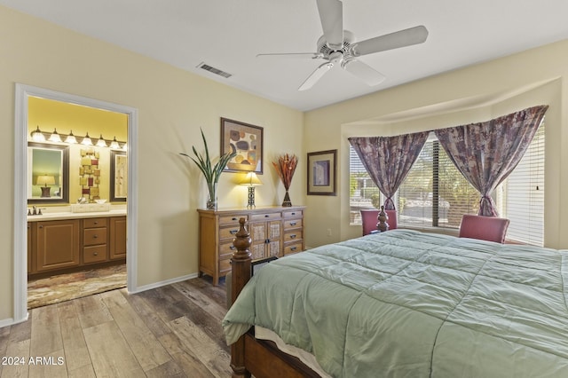 bedroom featuring ceiling fan, hardwood / wood-style floors, and connected bathroom