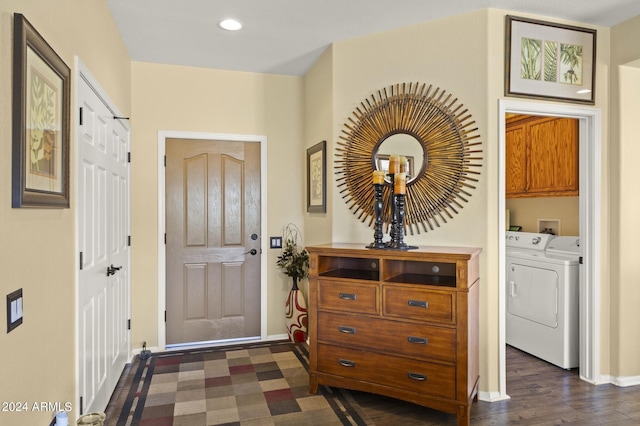 entryway with dark wood-type flooring and washing machine and clothes dryer