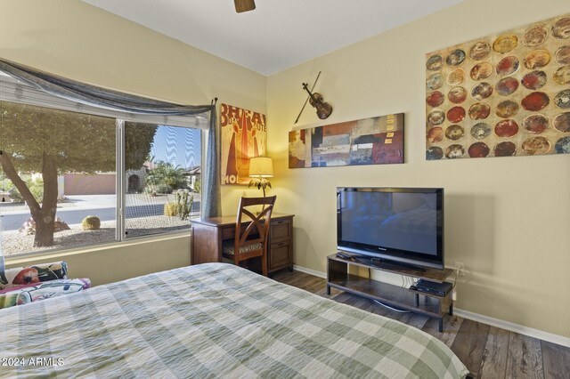 bedroom with ceiling fan and dark hardwood / wood-style floors