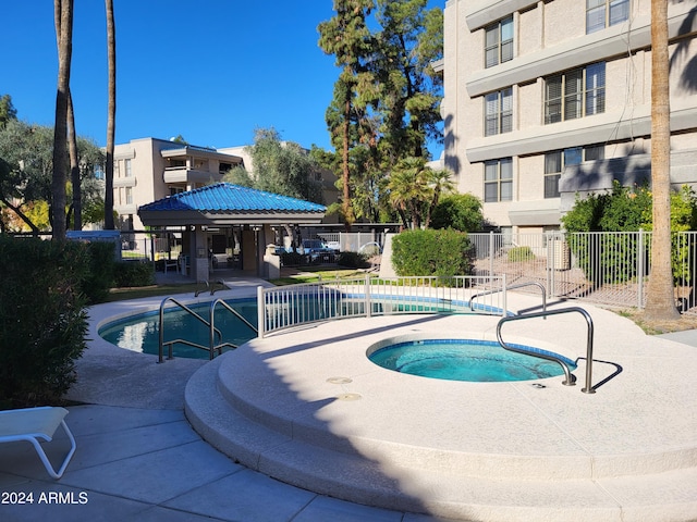 view of pool with a gazebo, a patio, and a hot tub