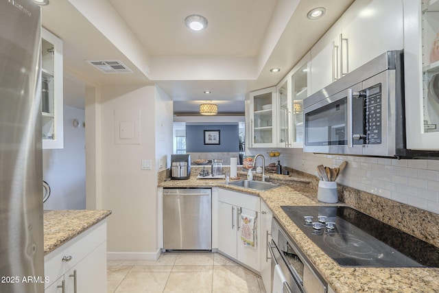 kitchen with white cabinets, light tile patterned floors, sink, and appliances with stainless steel finishes