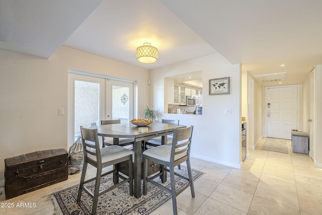 tiled dining area with french doors