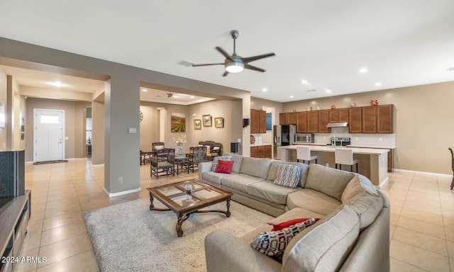 tiled living room with ceiling fan