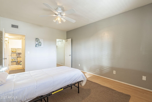 bedroom with wood-type flooring and ceiling fan