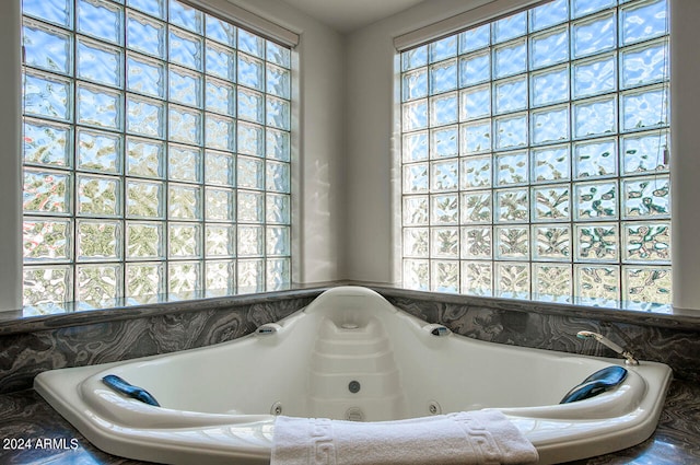 bathroom with a relaxing tiled tub