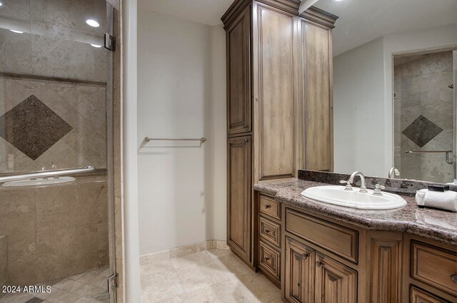 bathroom featuring an enclosed shower and vanity