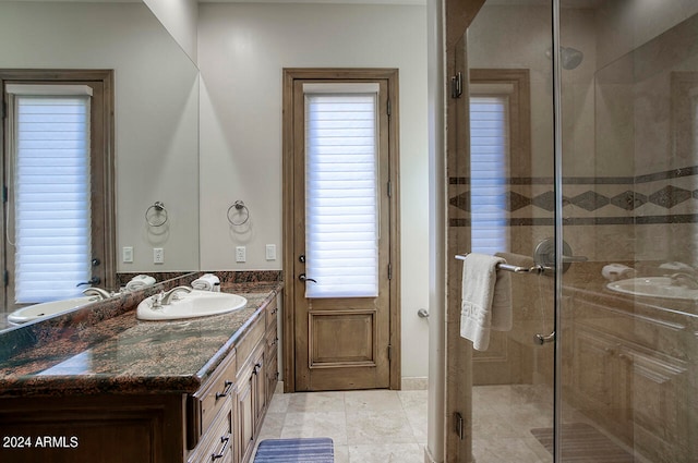 bathroom featuring tile patterned flooring, walk in shower, and vanity