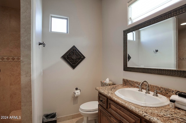 bathroom featuring toilet, vanity, and tile patterned floors