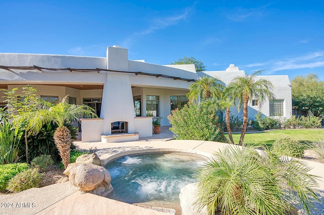 view of swimming pool with a hot tub