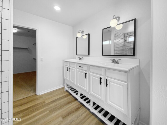 bathroom with double sink vanity and hardwood / wood-style floors