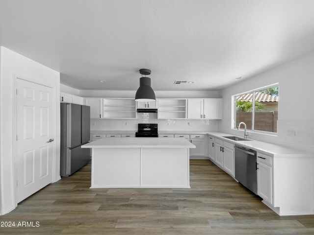 kitchen featuring a center island, appliances with stainless steel finishes, wood-type flooring, and white cabinetry