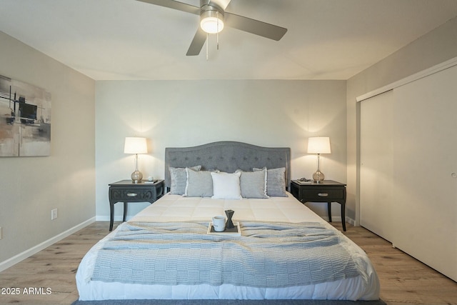 bedroom with a ceiling fan, a closet, baseboards, and wood finished floors