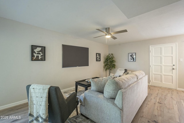 living room with light wood-style floors, ceiling fan, and baseboards