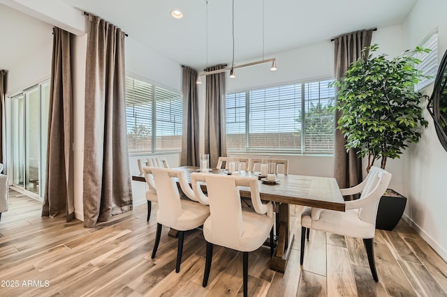 dining space with light wood-style floors, recessed lighting, and baseboards