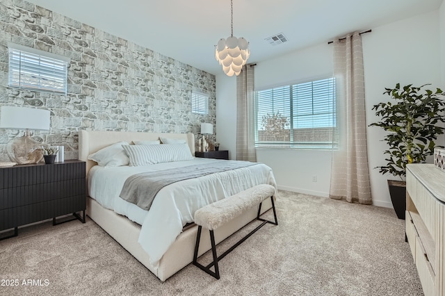 bedroom featuring visible vents, light carpet, and baseboards