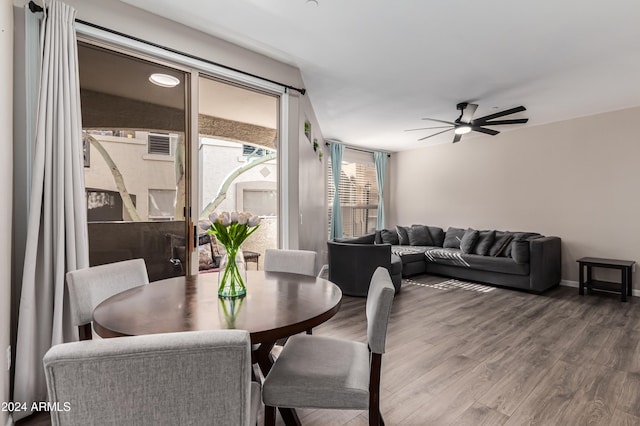 dining space with ceiling fan and wood-type flooring