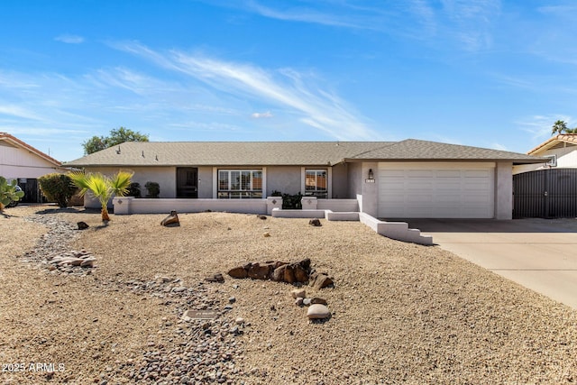 single story home featuring a garage, driveway, and stucco siding