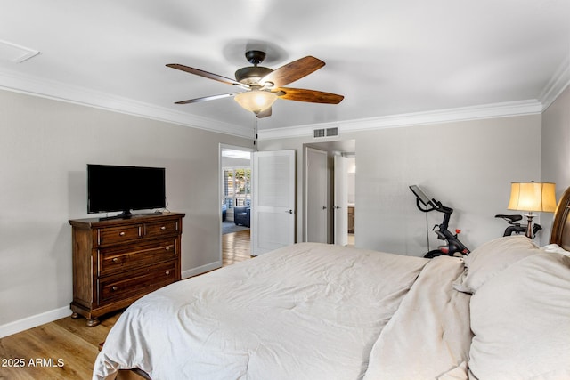 bedroom with crown molding, visible vents, light wood-style floors, ceiling fan, and baseboards