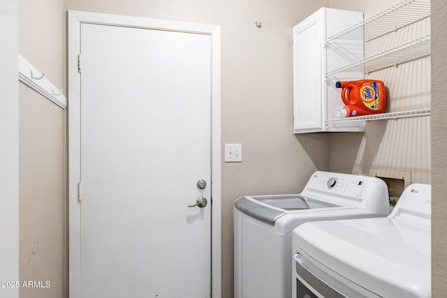 laundry area featuring cabinet space and washing machine and clothes dryer