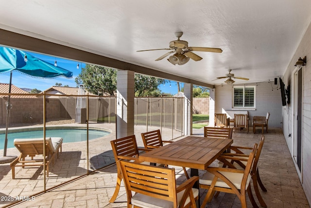 view of patio / terrace with a fenced backyard, ceiling fan, a fenced in pool, and outdoor dining space