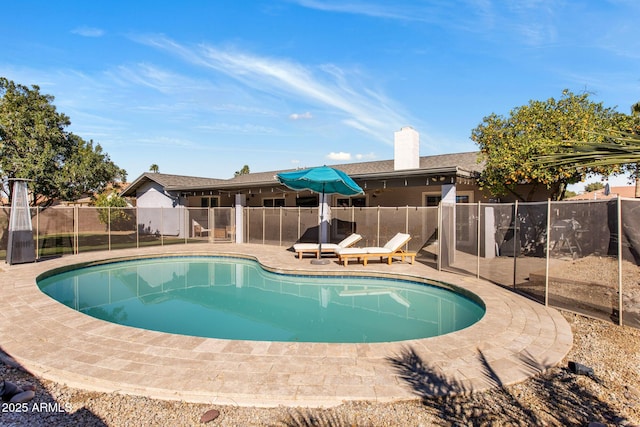 view of swimming pool with a fenced in pool, fence, and a patio