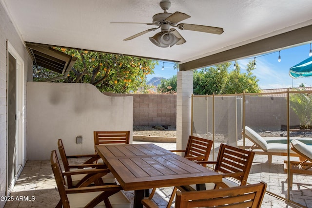 view of patio featuring ceiling fan, outdoor dining space, and a fenced backyard