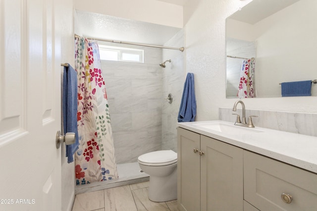 bathroom featuring vanity, toilet, and walk in shower