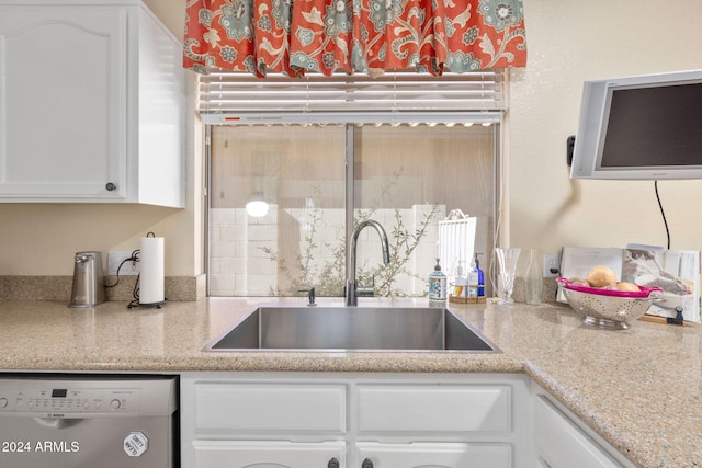 kitchen with white cabinetry, dishwasher, light stone countertops, and sink