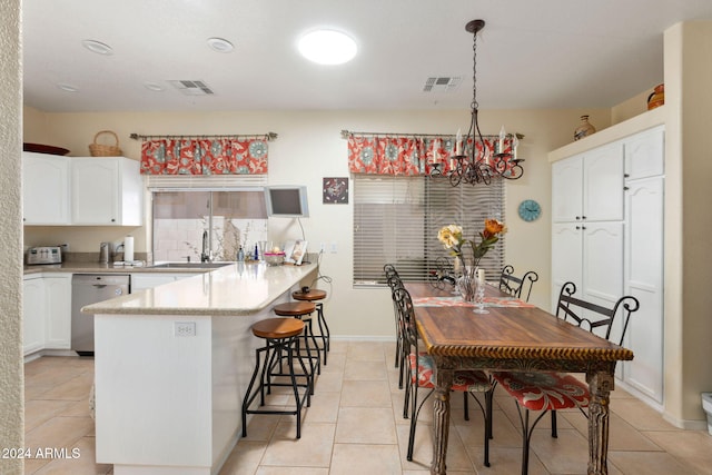 tiled dining area featuring sink and a chandelier