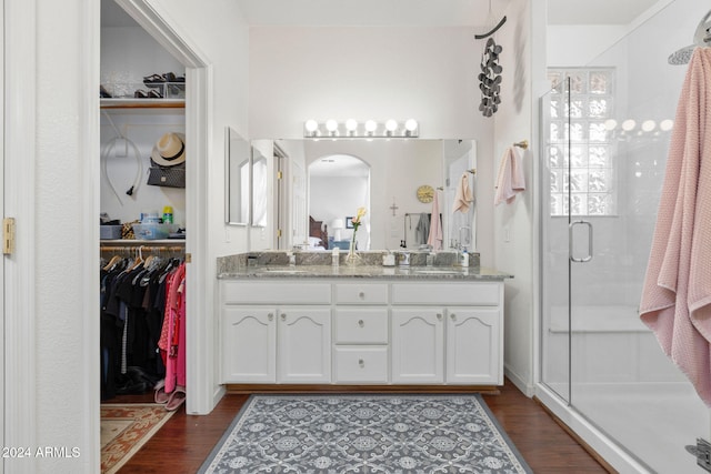 bathroom featuring vanity, an enclosed shower, and hardwood / wood-style floors