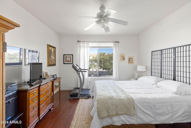 bedroom with ceiling fan and dark hardwood / wood-style flooring