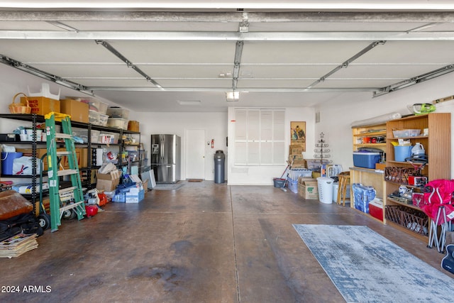 garage with stainless steel refrigerator with ice dispenser