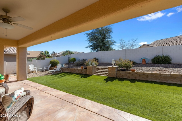 view of yard with a patio and ceiling fan