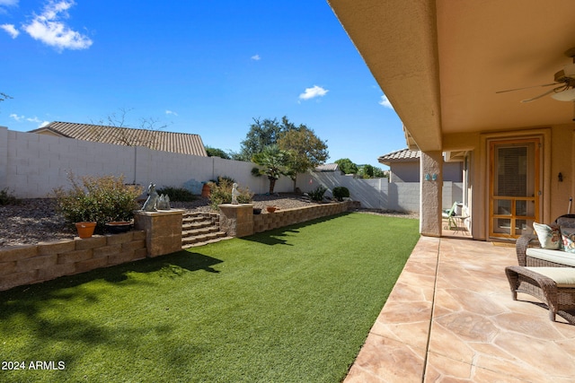 view of yard featuring a patio and ceiling fan