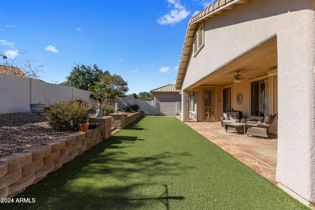 view of yard with outdoor lounge area, a patio area, and ceiling fan