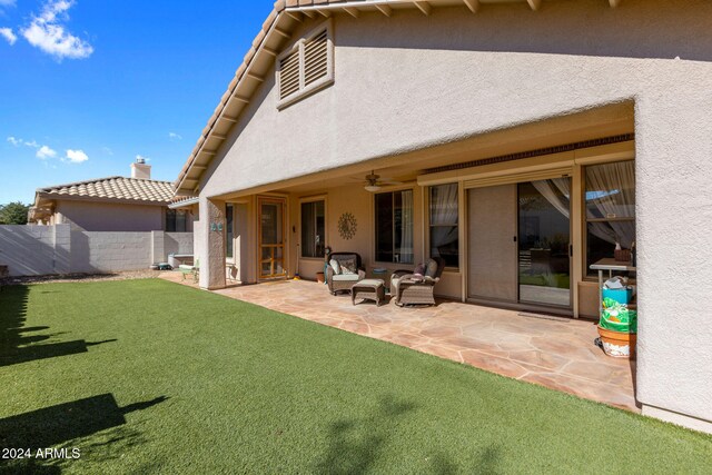 back of house featuring a patio and a lawn