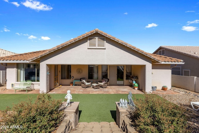 rear view of property with a patio and a lawn