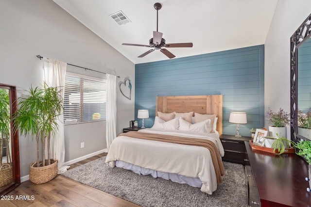 bedroom featuring hardwood / wood-style flooring, lofted ceiling, and ceiling fan