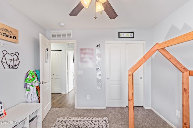 interior space featuring carpet floors, ceiling fan, and a closet